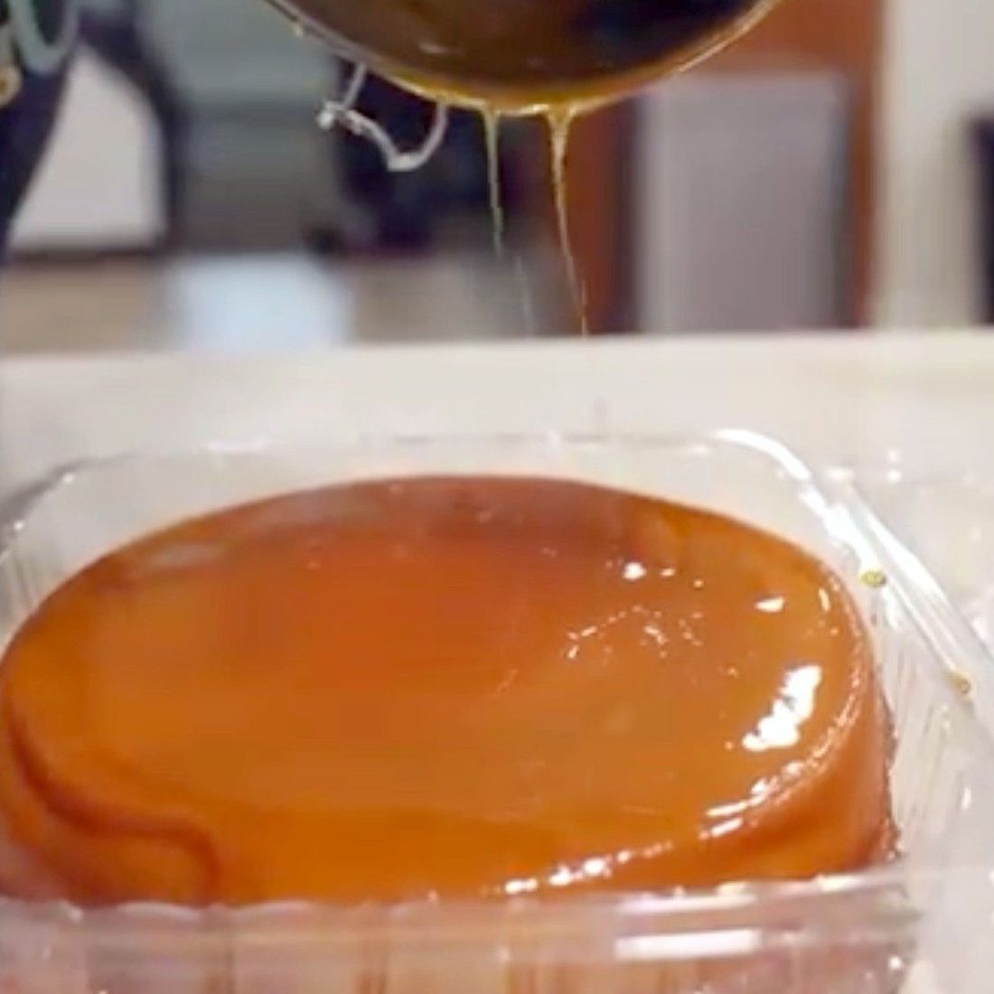 Caramel being poured over a homemade cream cheese flan by Prima AZ in Avondale, AZ