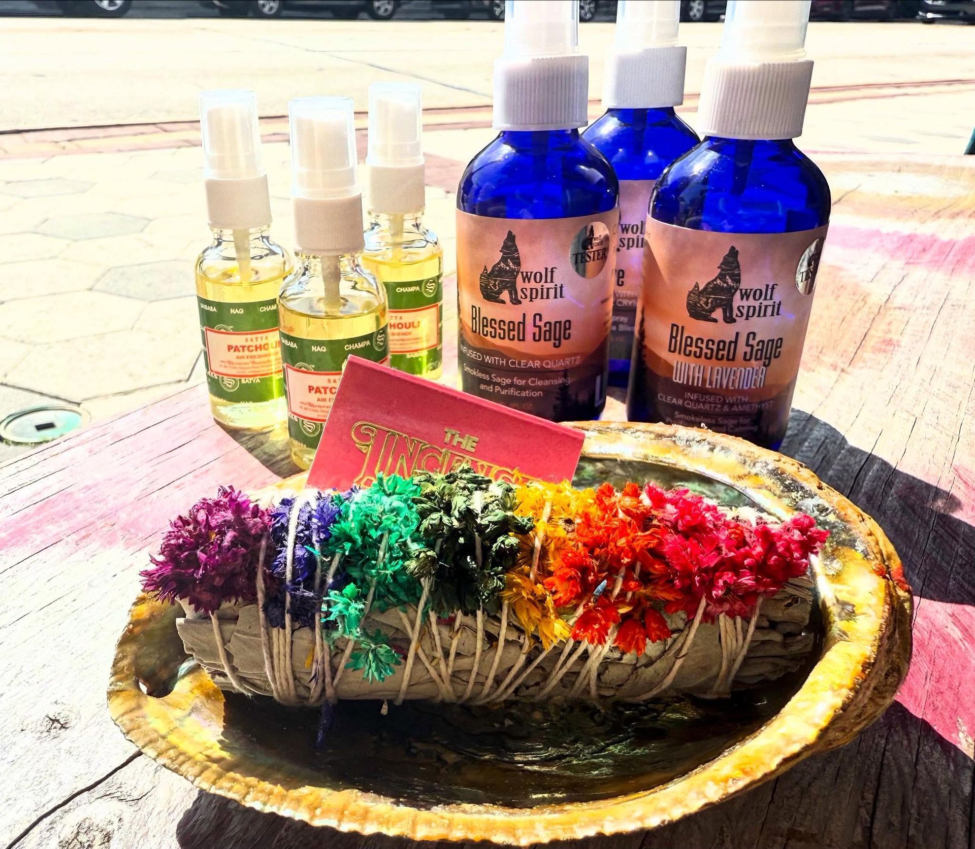Colorful handmade soap bars with essential oil bottles on a sunlit table