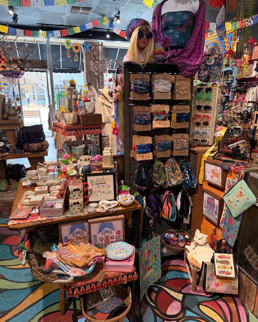 Colorful boutique display of handmade jewelry, bags, and trinkets in a small shop