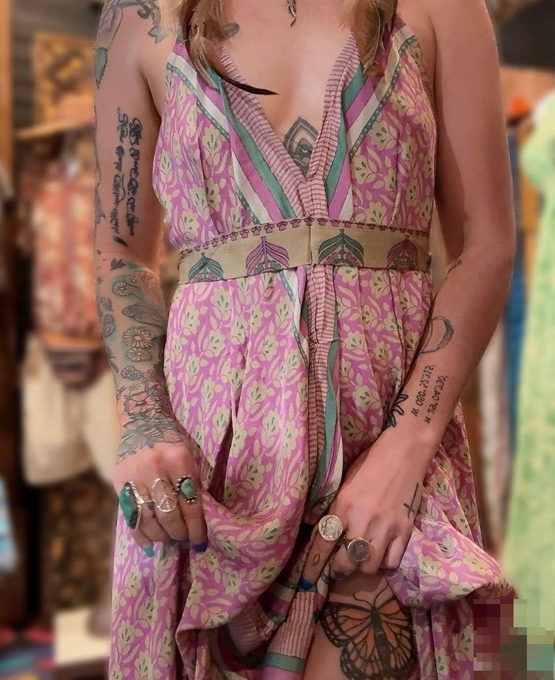 Colorful clothing shop with patterned dresses, hanging garments, and vibrant painted decor.