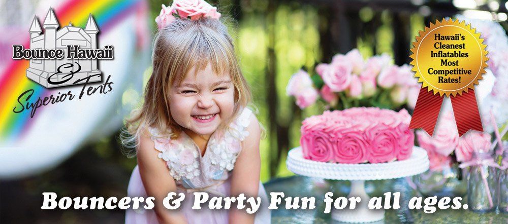 A little girl is smiling in front of a cake.