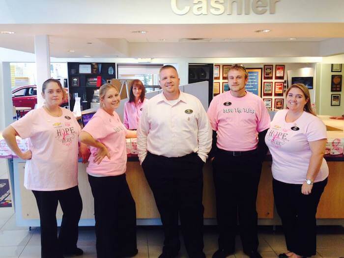 Employees in pink shirts for breast cancer awareness