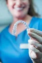 Dentist woman holding Clear Aligners