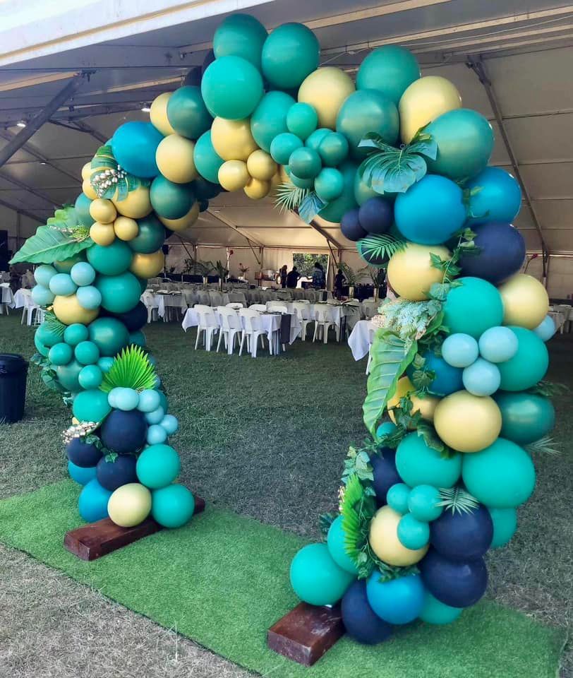 Balloon Arch in Shades of Green, Yellow, and Blue, Decorated With Leaves — Creative Events Innisfail in Innisfail, QLD