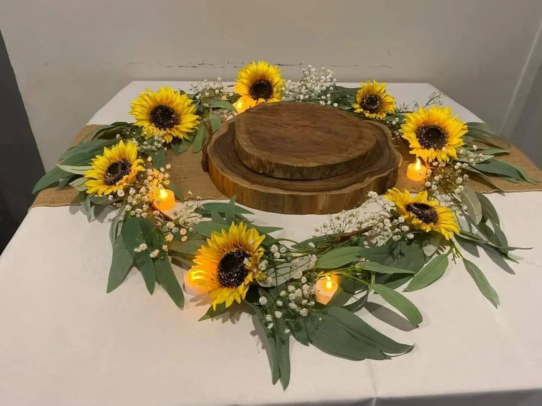 Sunflower Centerpiece on a White Tablecloth — Creative Events Innisfail in Innisfail, QLD