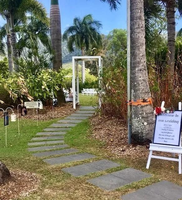 Stone Path Leads to White Archway and Wedding Ceremony — Creative Events Innisfail in Tully, QLD