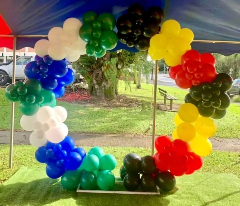 Colorful Balloon Arch in Olympic Rings Colors, Set Outdoors on Grass — Creative Events Innisfail in Mission Beach, QLD