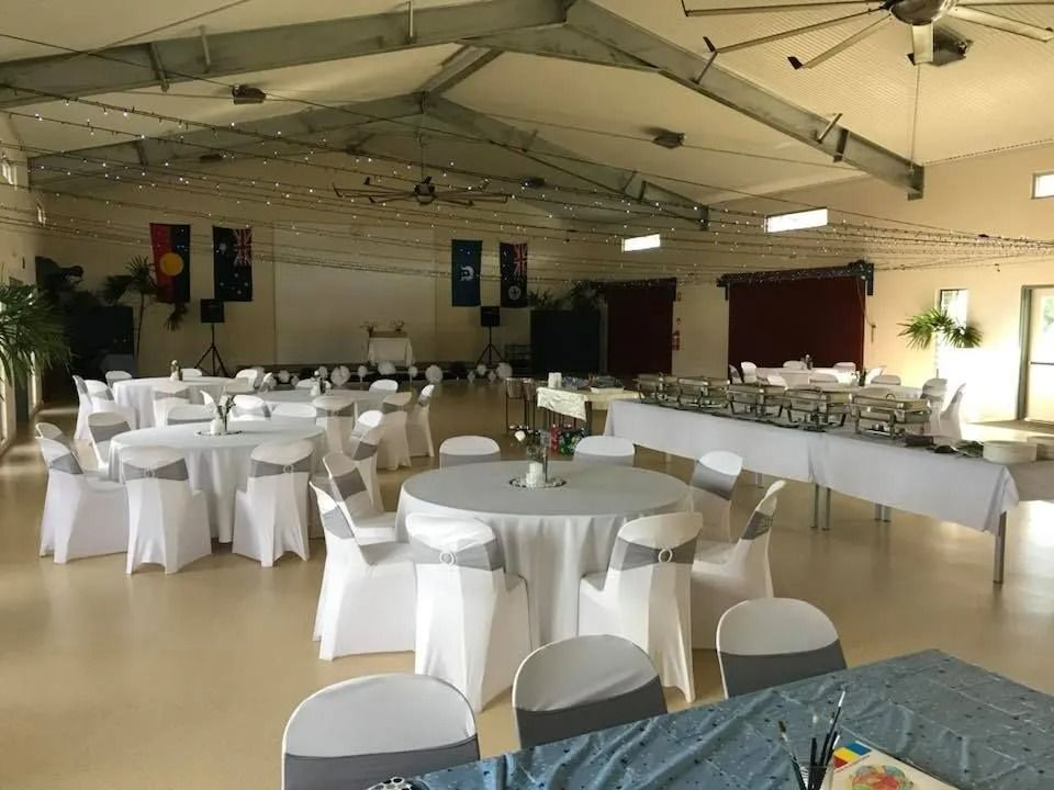 Banquet Hall Set for Event With Round Tables, White Chairs — Creative Events Innisfail in Babinda, QLD