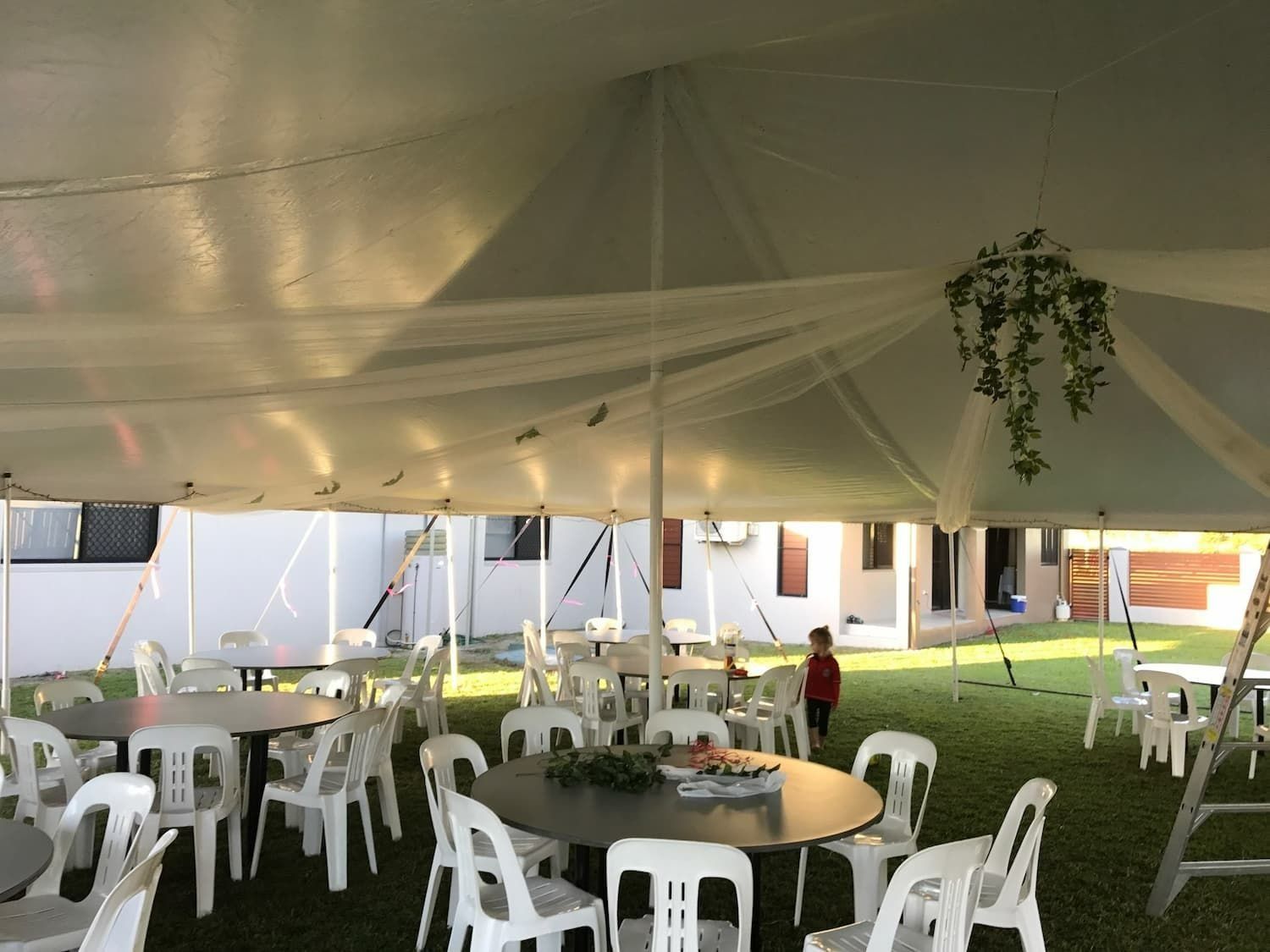 White Tent With Tables and Chairs Set Up on Grass — Creative Events Innisfail in Mission Beach, QLD