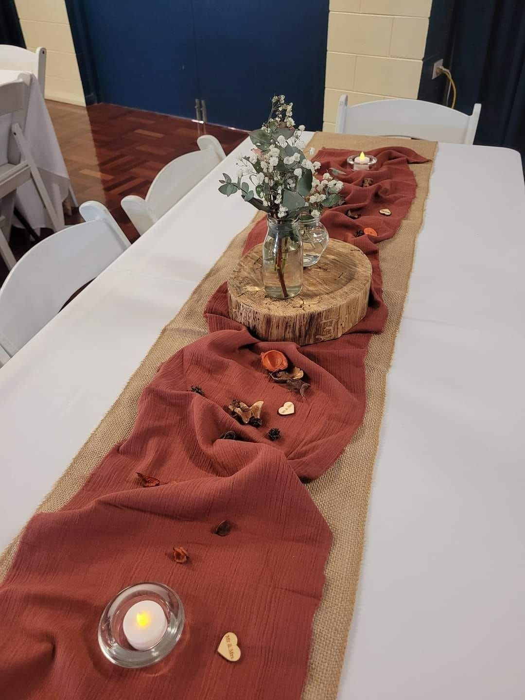 Table Setting With Floral Centerpiece and Terracotta-colored Runner — Creative Events Innisfail in Tully, QLD