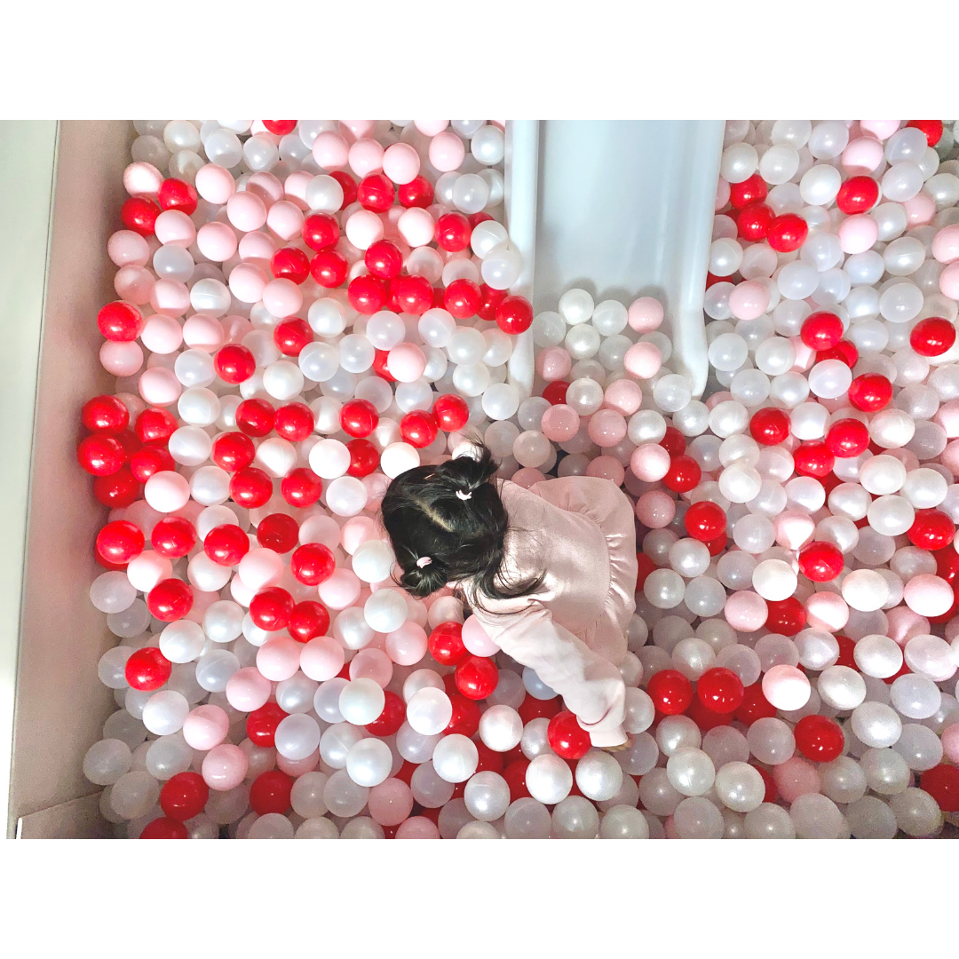 Toddler playing in colorful soft play ball pit in Philadelphia
