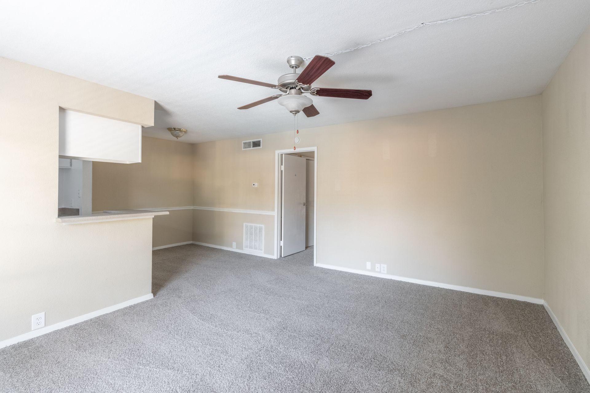 Living room with carpet with Rockridge Station.