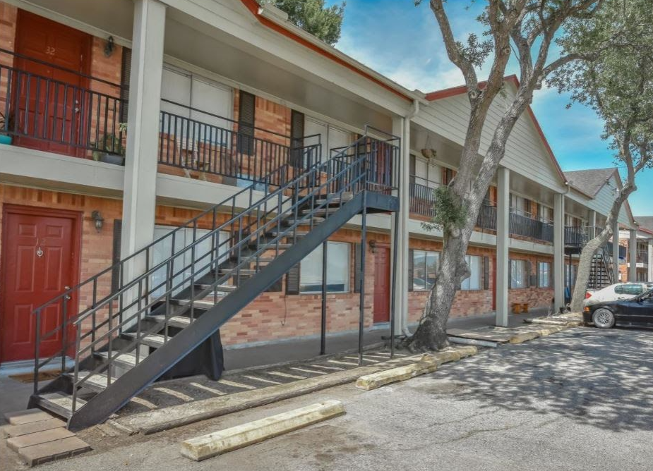 a large apartment building with stairs leading up to the second floor .