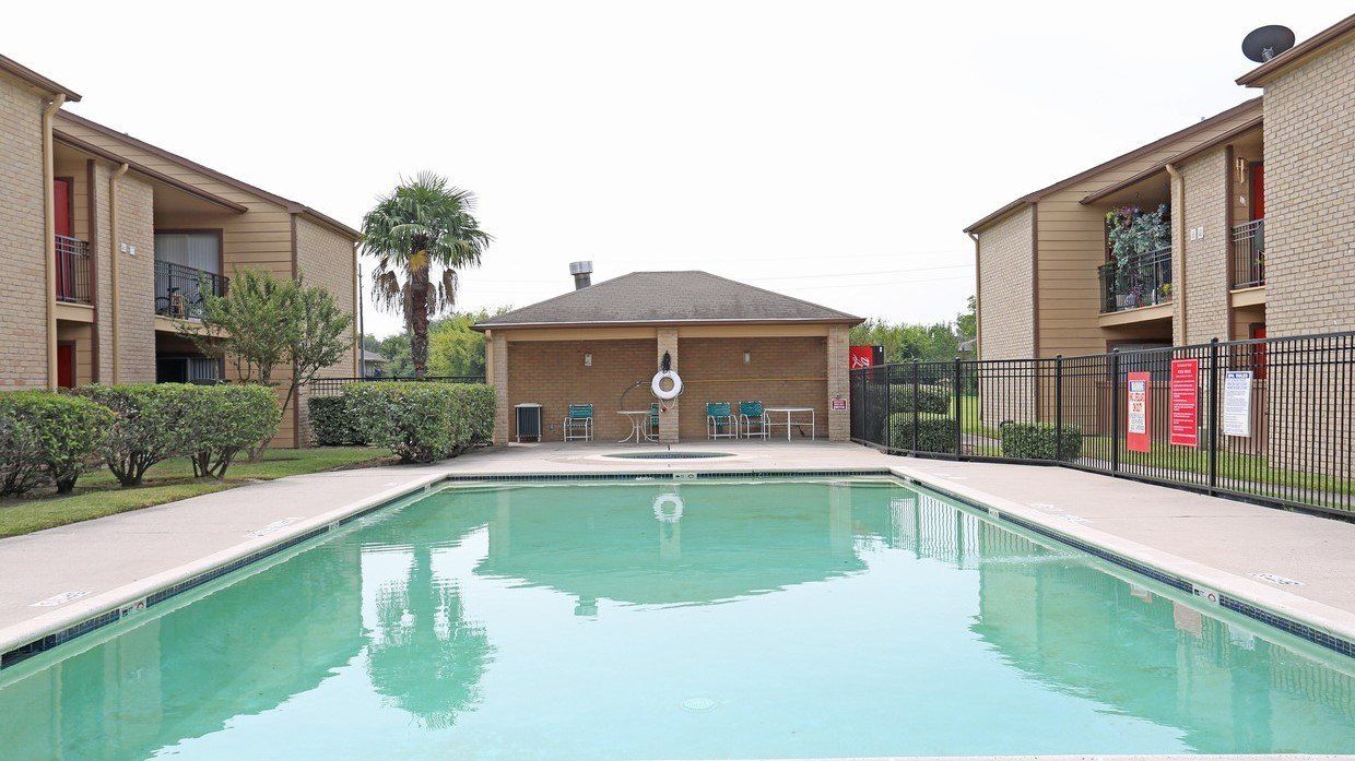 a large swimming pool surrounded by buildings in a residential area In Rockridge park apartments 