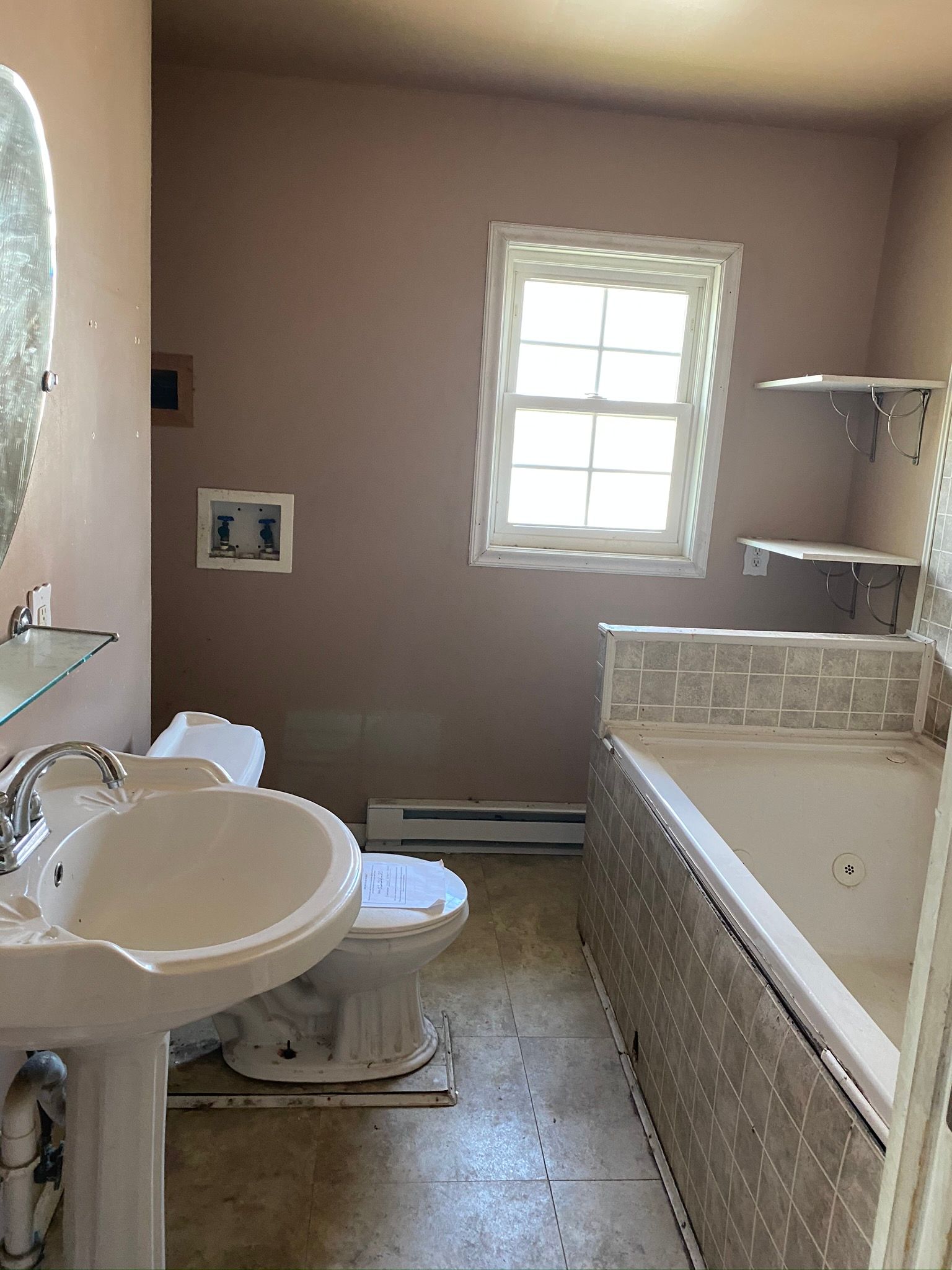 A bathroom with a sink , toilet , and bathtub.