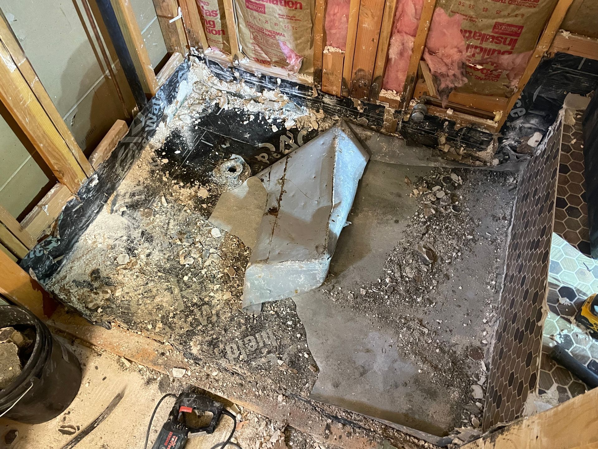 A bathtub is being remodeled in a bathroom.