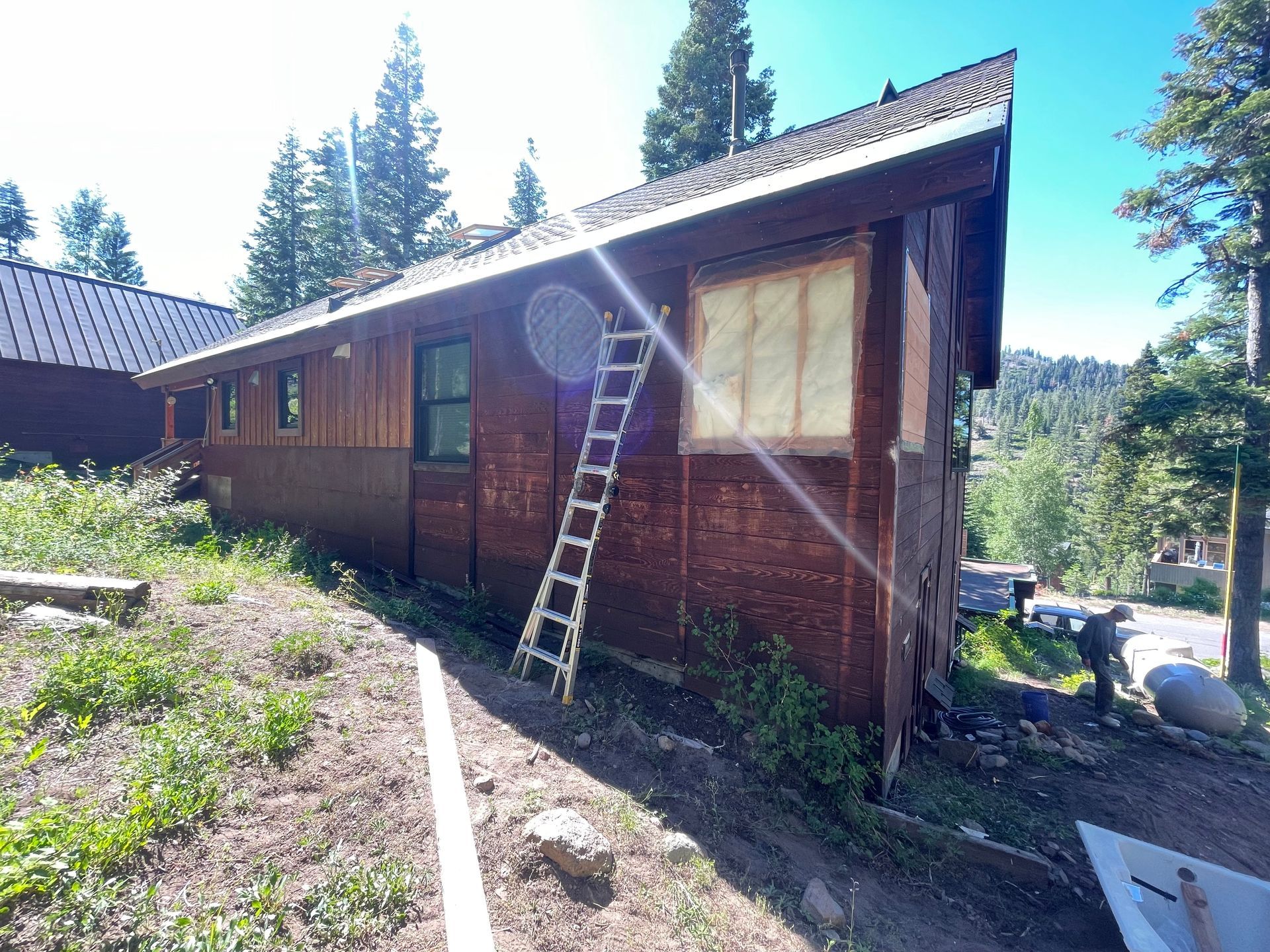 A wooden house with a ladder on the side of it