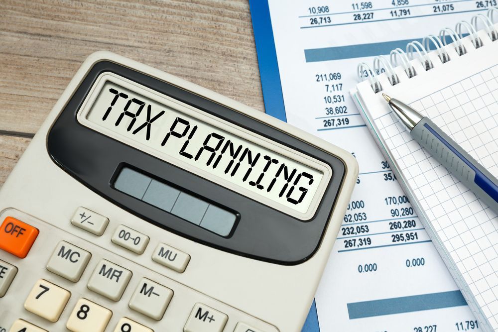 Calculator Displaying Tax Planning on A Desk with Documents and A Notepad — Wright Partners in Brewarrina, NSW