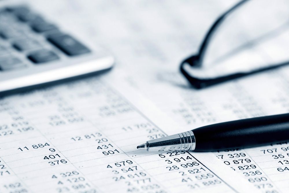 Close-Up of Financial Documents with A Pen, Glasses, and Calculator — Wright Partners in Wellington, NSW