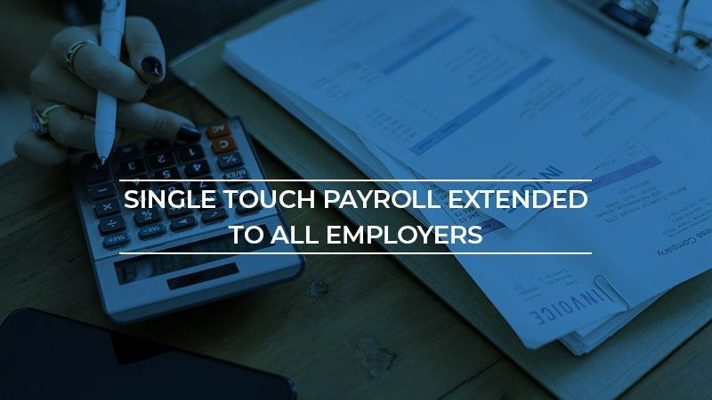 Person Using a Calculator with Documents; Text Single Touch Payroll Extended to All Employers — Wright Partners in Dubbo, NSW