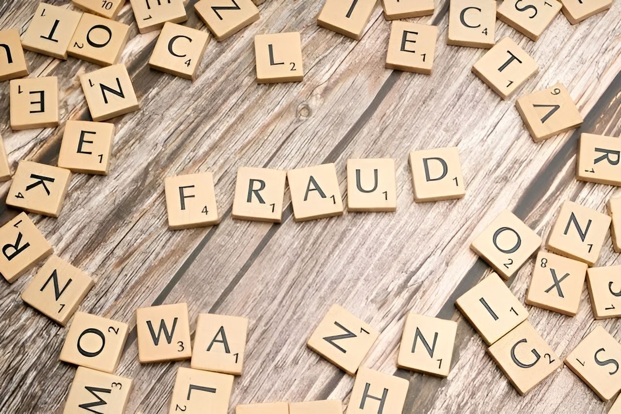 Scrabble Tiles Spelling Fraud Surrounded by Other Letter Tiles — Wright Partners in Dubbo, NSW