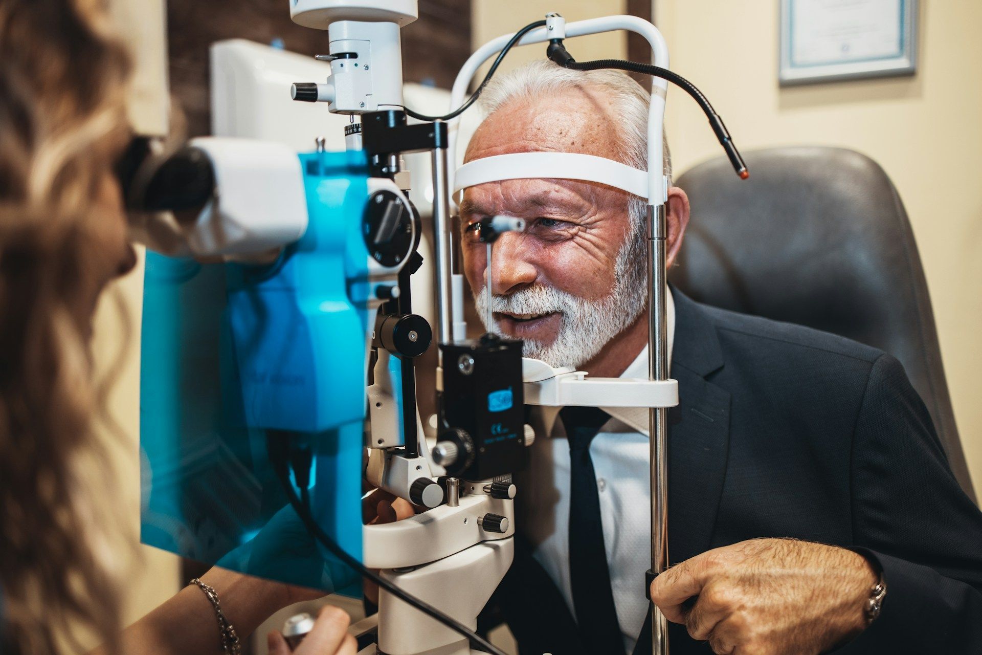 Optometrist examining a patient’s eye with a slit lamp in a clinic