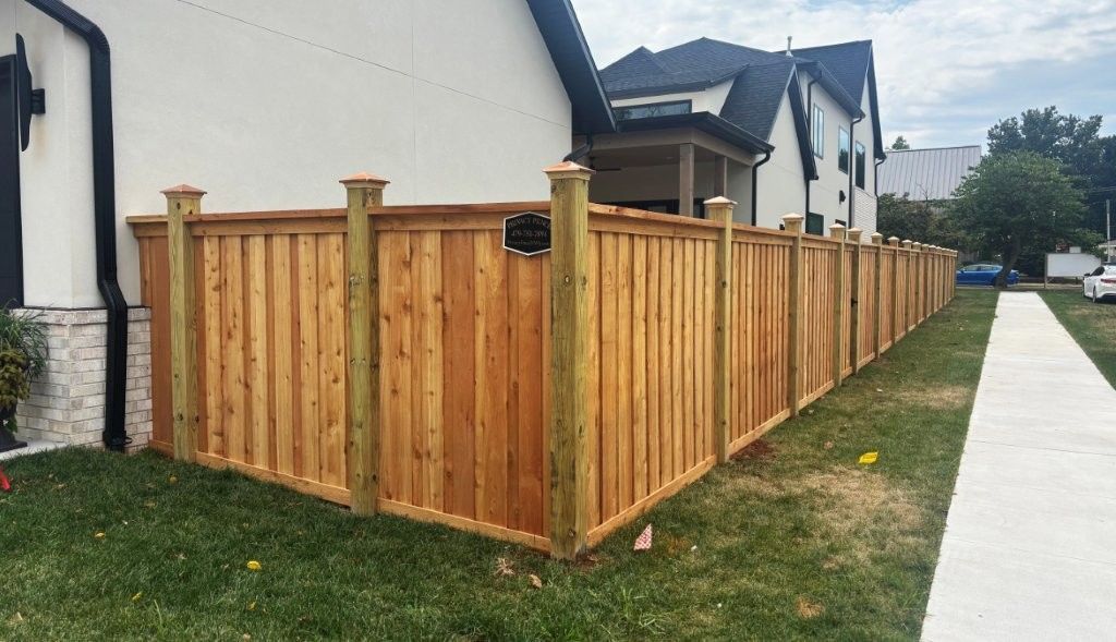 Board on board fence with decorative posts