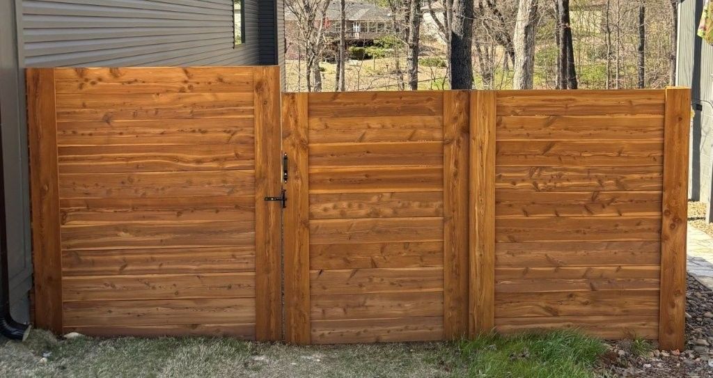 stained horizontal fence with gate
