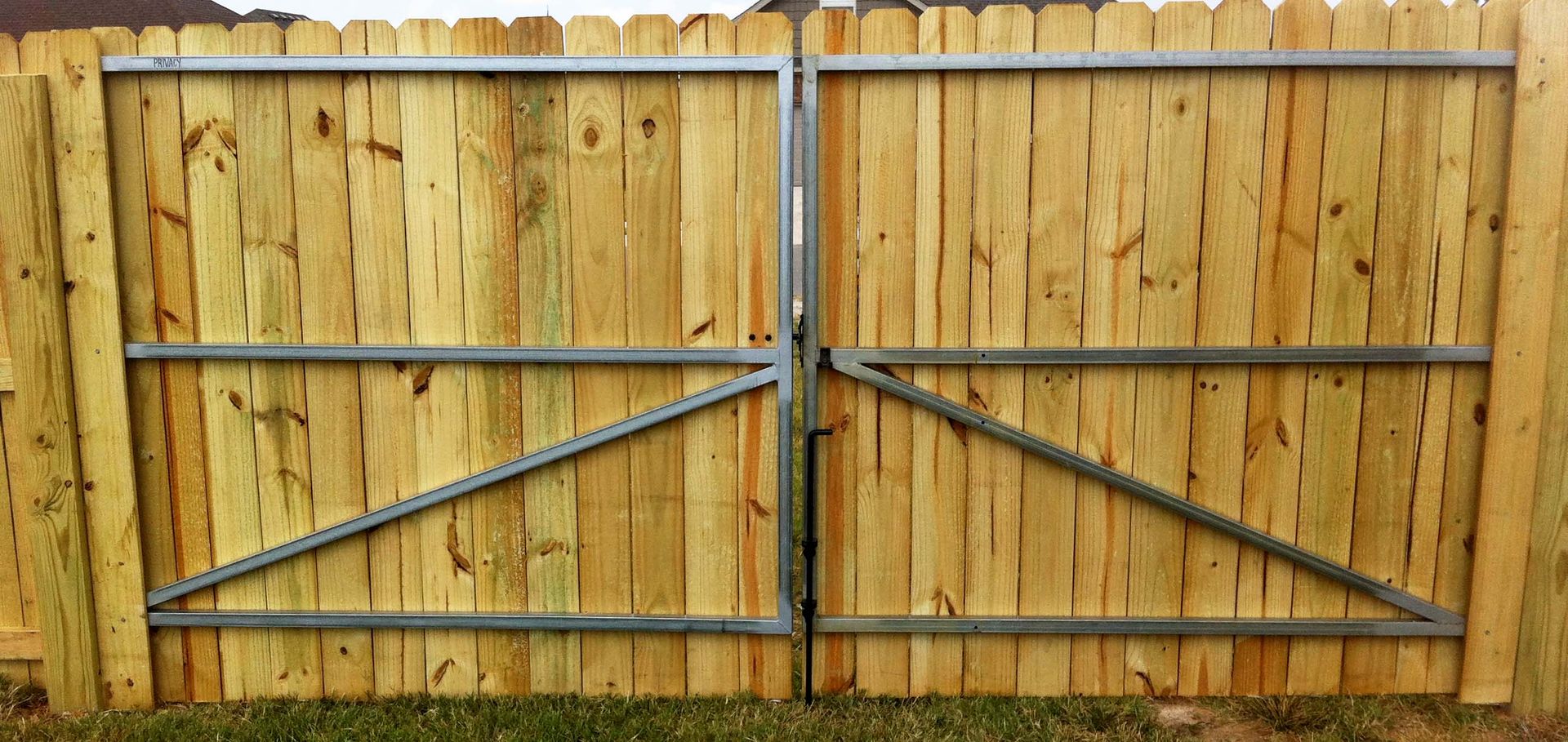 a wooden gate has a metal frame around it