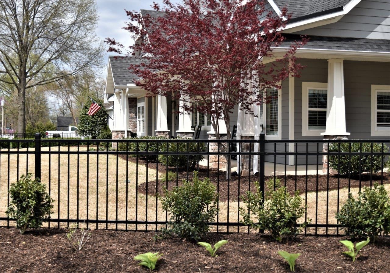 iron fence with house 