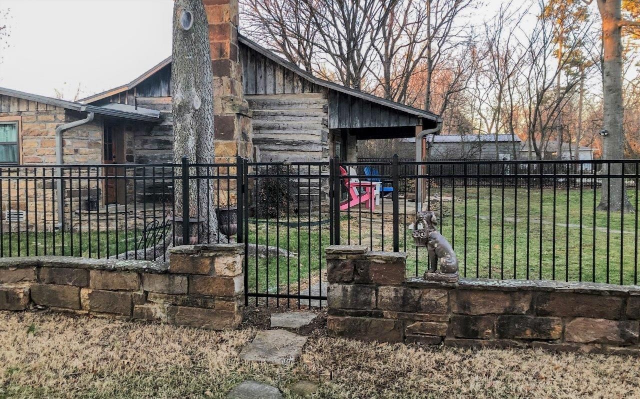 ornamental iron fence with rock wall