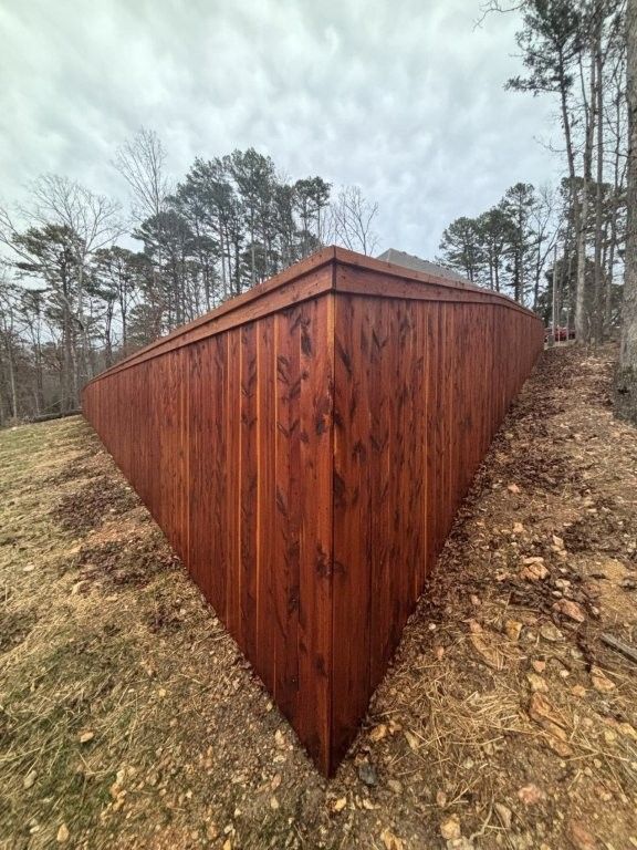 a cedar wooden fence with stain
