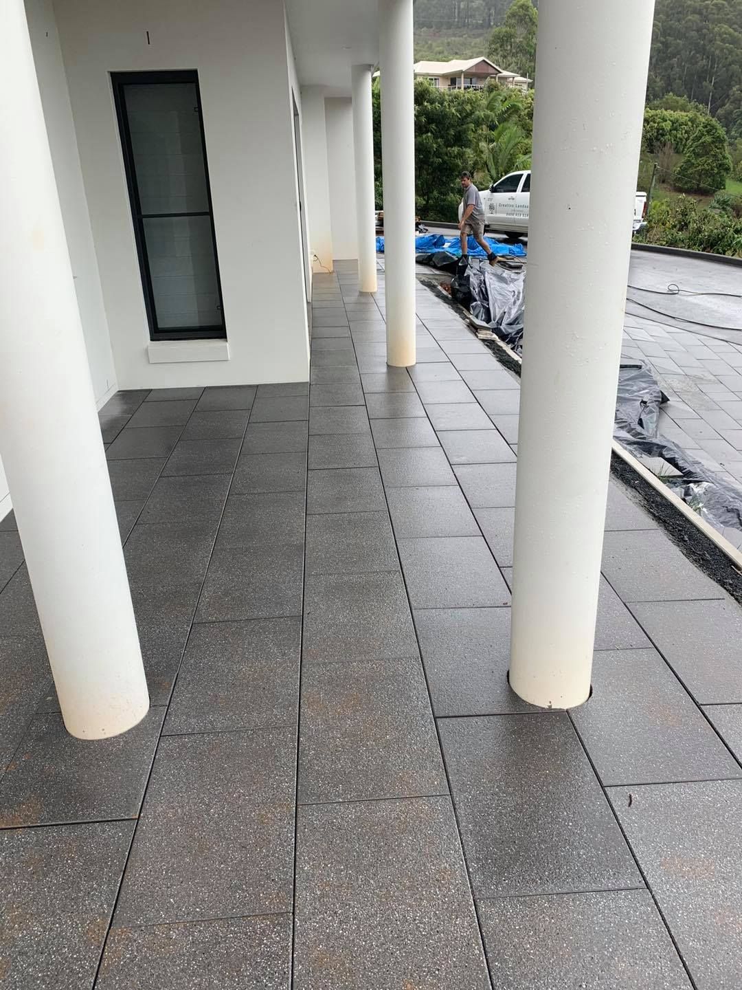 A Covered Outdoor Patio with Grey Stone Tiles — Creative Landscapes Coffs Harbour in Sandy Beach, NSW