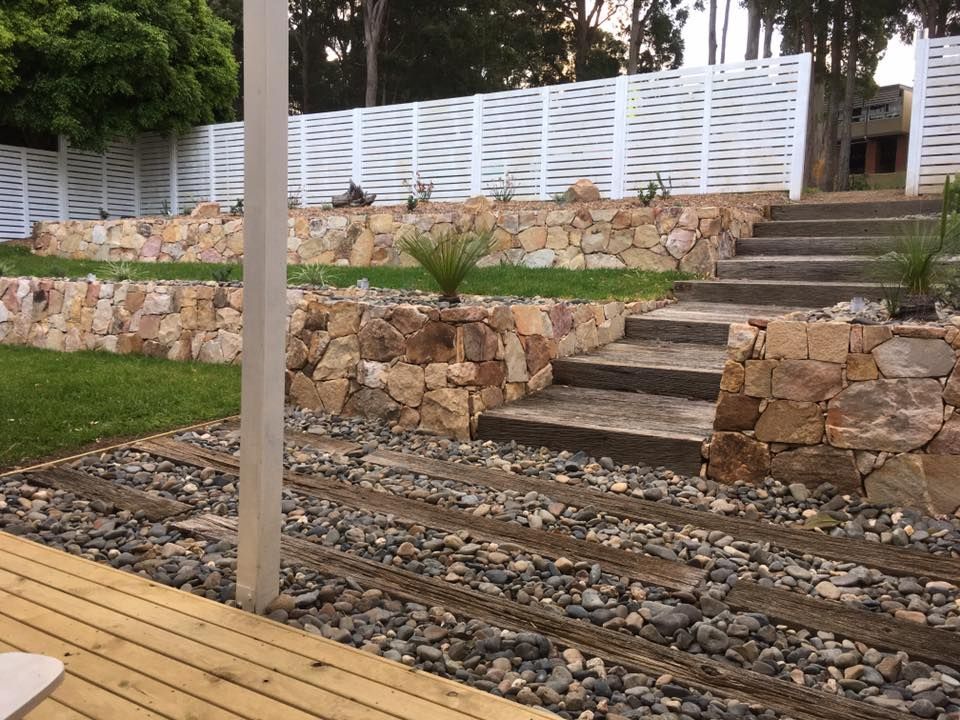 Terraced Stone Retaining Walls with Wooden Steps — Creative Landscapes Coffs Harbour in Korora, NSW