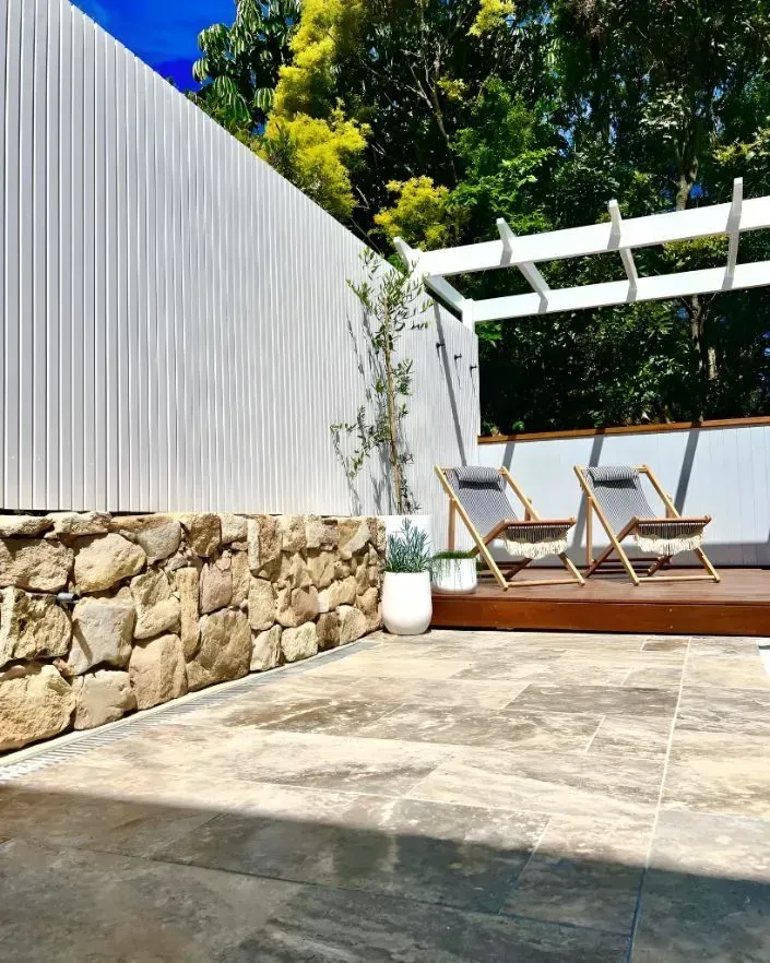 A Sunlit Outdoor Patio Featuring Stone Walls — Creative Landscapes Coffs Harbour in Korora, NSW