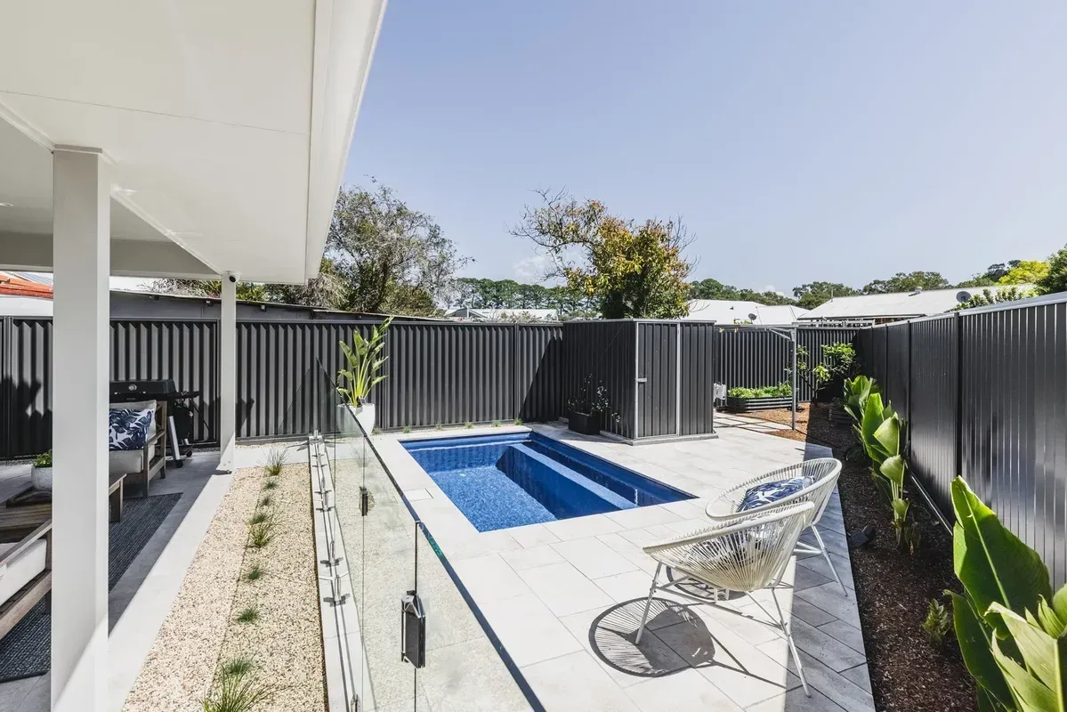 A Modern Backyard with A Rectangular Blue Plunge Pool — Creative Landscapes Coffs Harbour in Korora, NSW