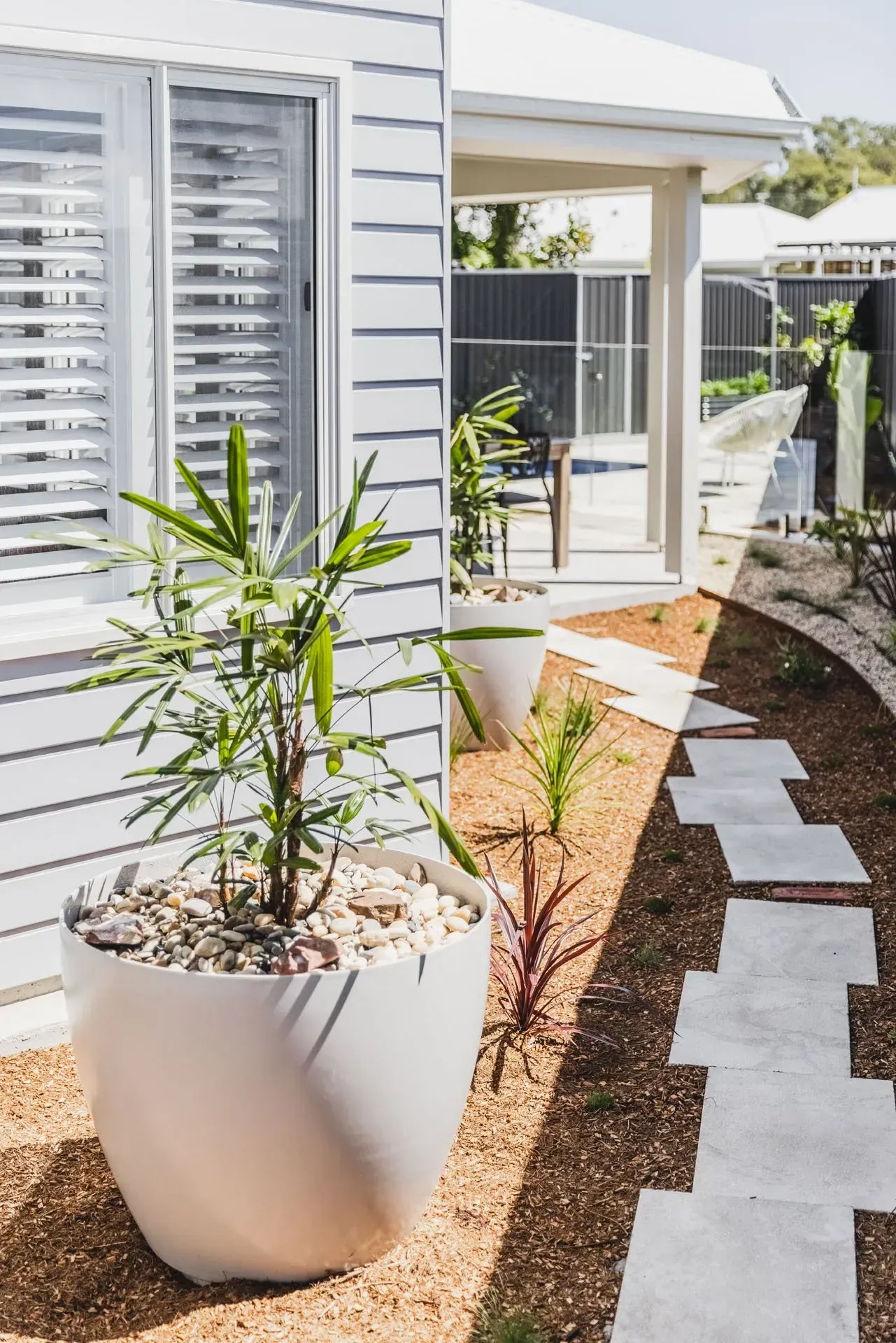 A White Pot with A Green Plant  — Creative Landscapes Coffs Harbour in Korora, NSW