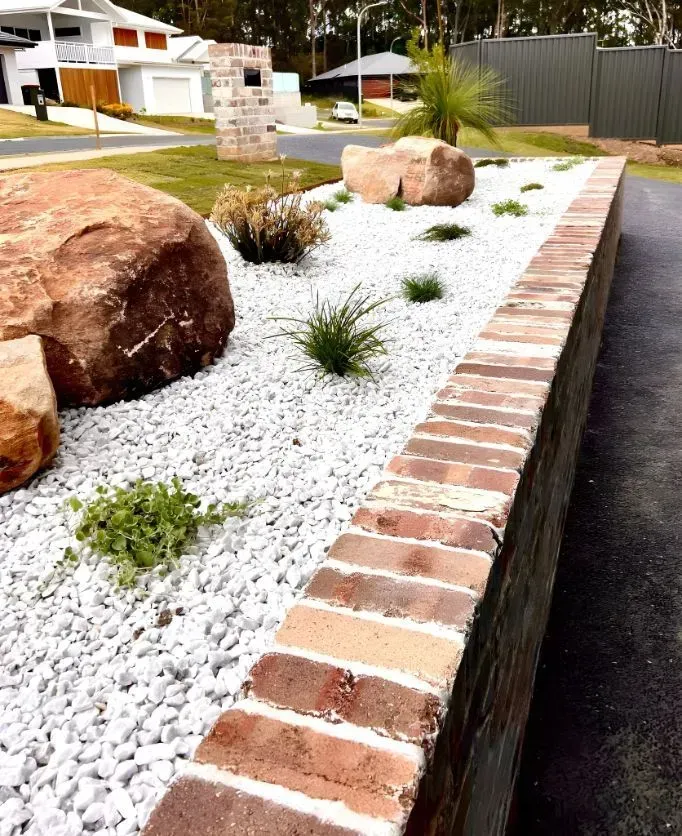 A Brick Retaining Wall Borders a Garden Bed — Creative Landscapes Coffs Harbour in Sawtell, NSW