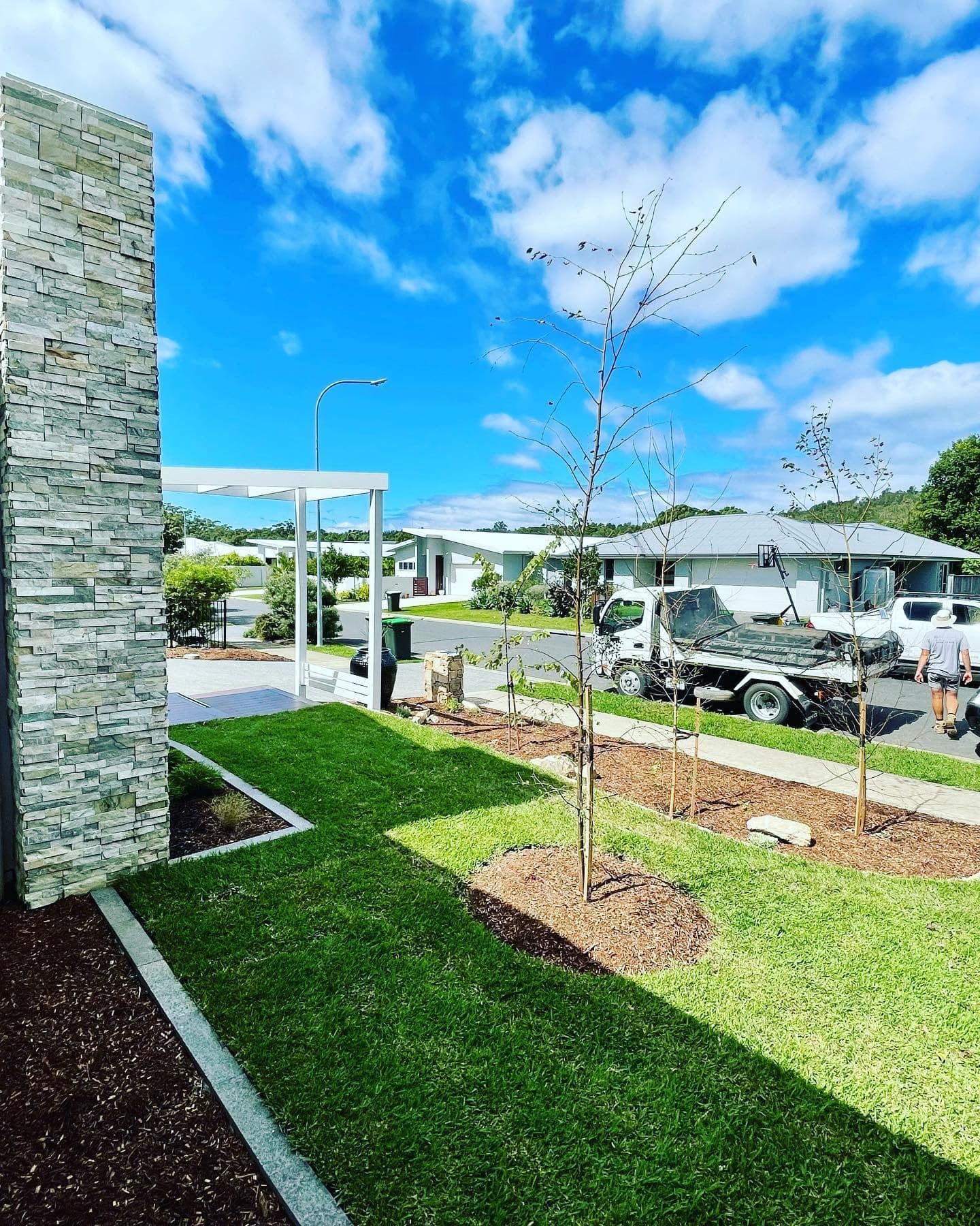 A Landscaped Residential Front Yard with A Stone Pillar — Creative Landscapes Coffs Harbour in Sawtell, NSW