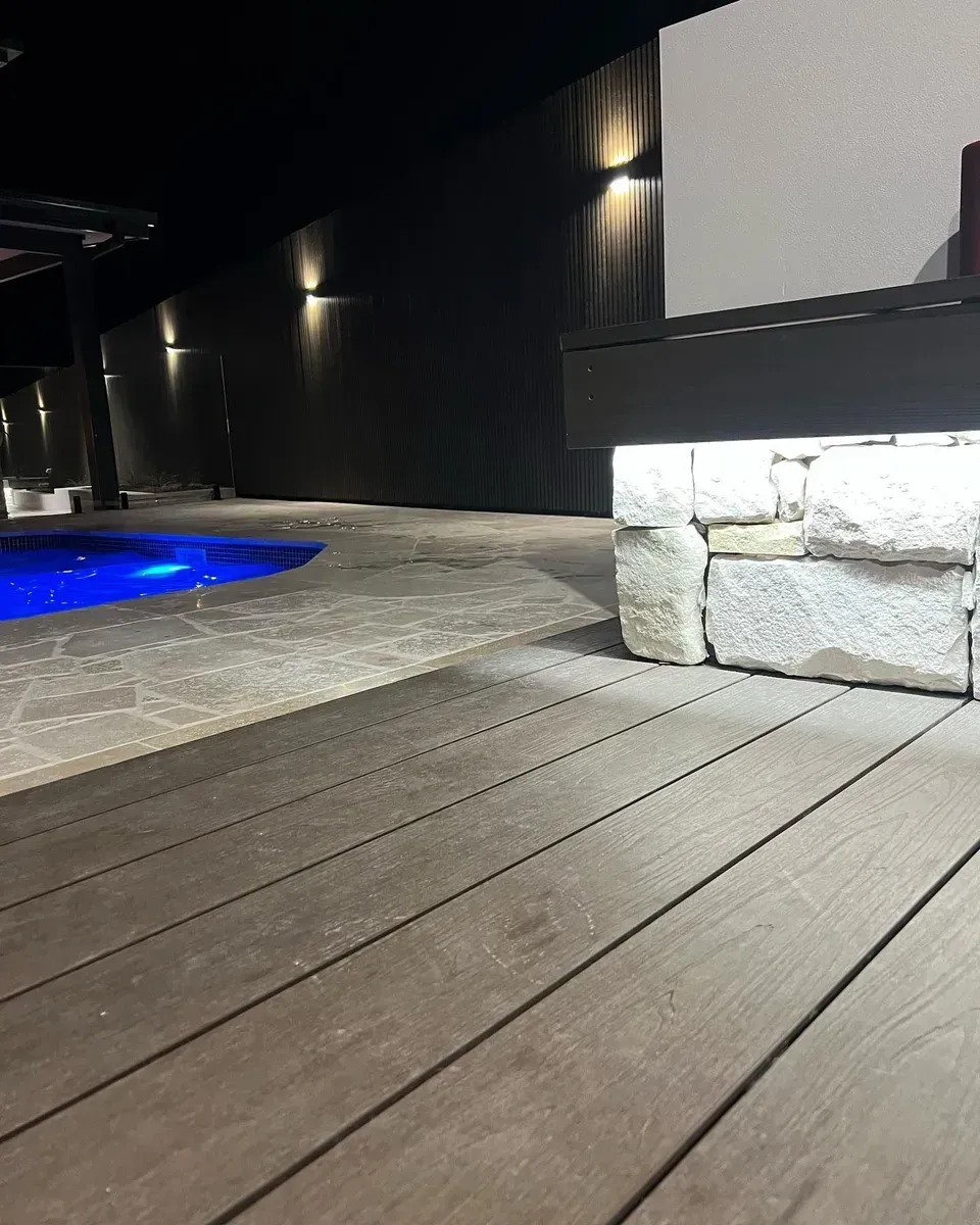 A Nighttime View of A Modern Patio with Dark Decking — Creative Landscapes Coffs Harbour in Korora, NSW