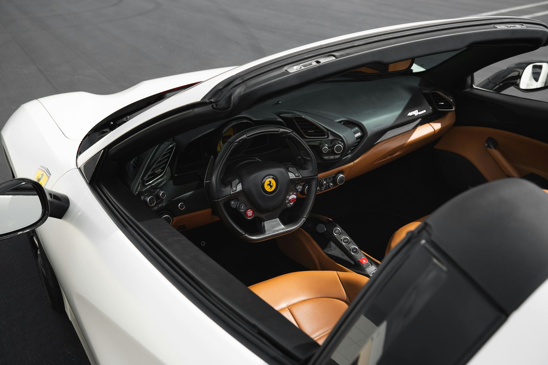 A red sports car is parked in a garage.