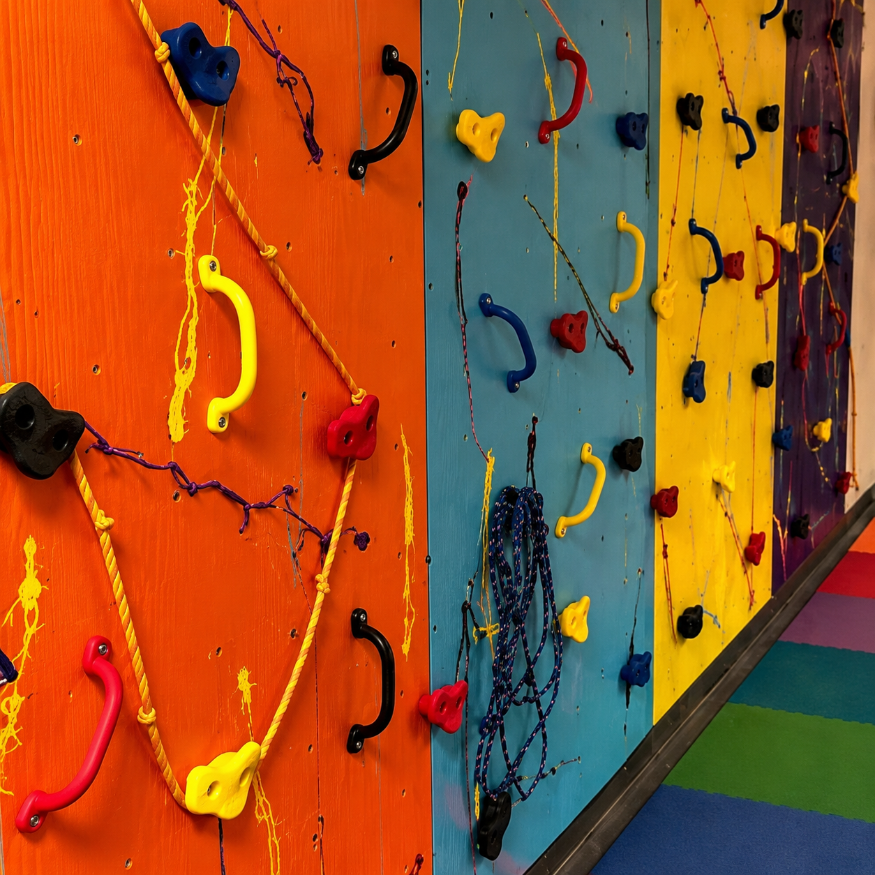 Colorful starter rock wall with climbing handles