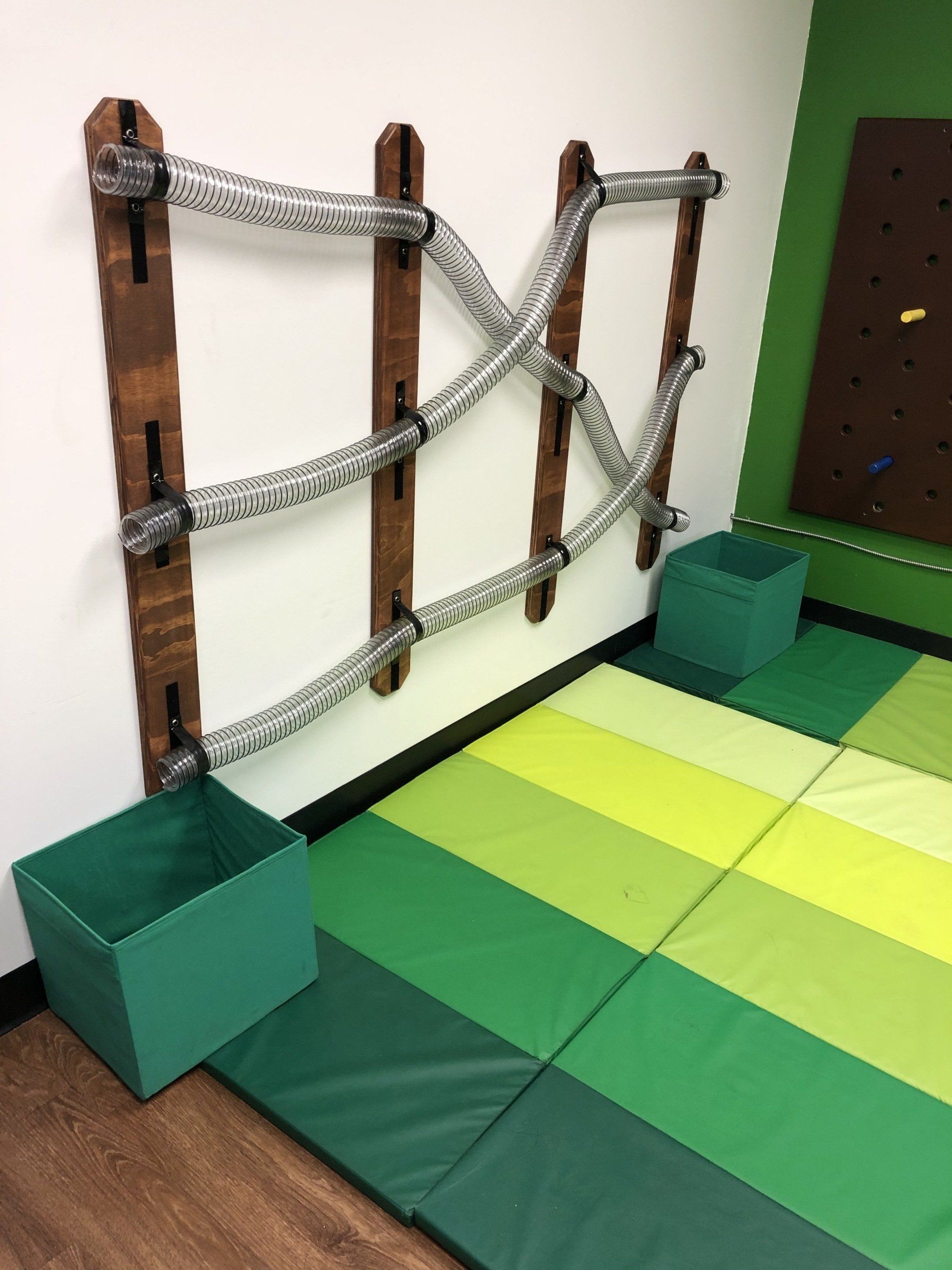 Sensory wall activity with ropes, bars, and climbing features for coordination and therapeutic movement