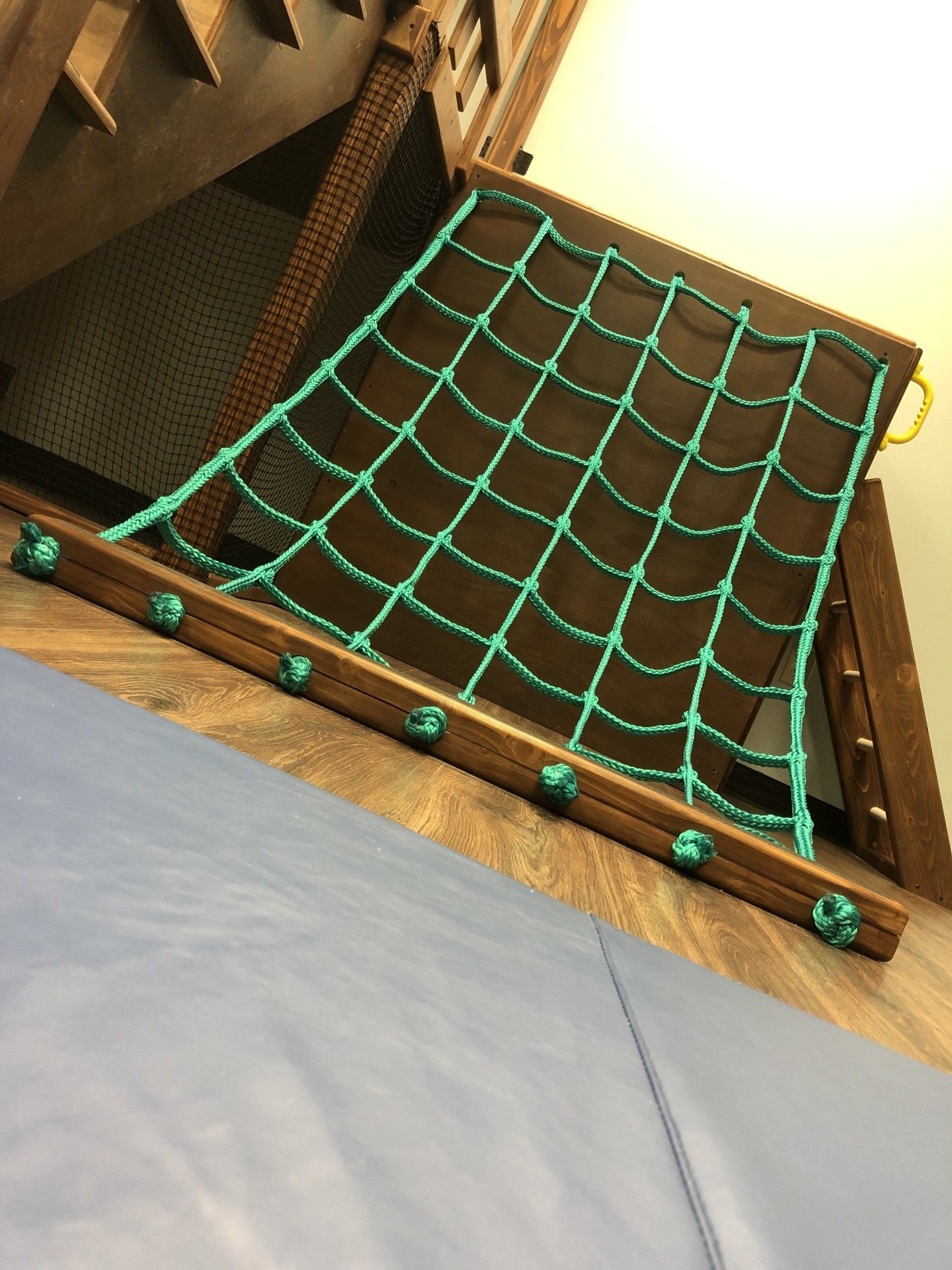 Indoor sensory gym cargo net climbing feature