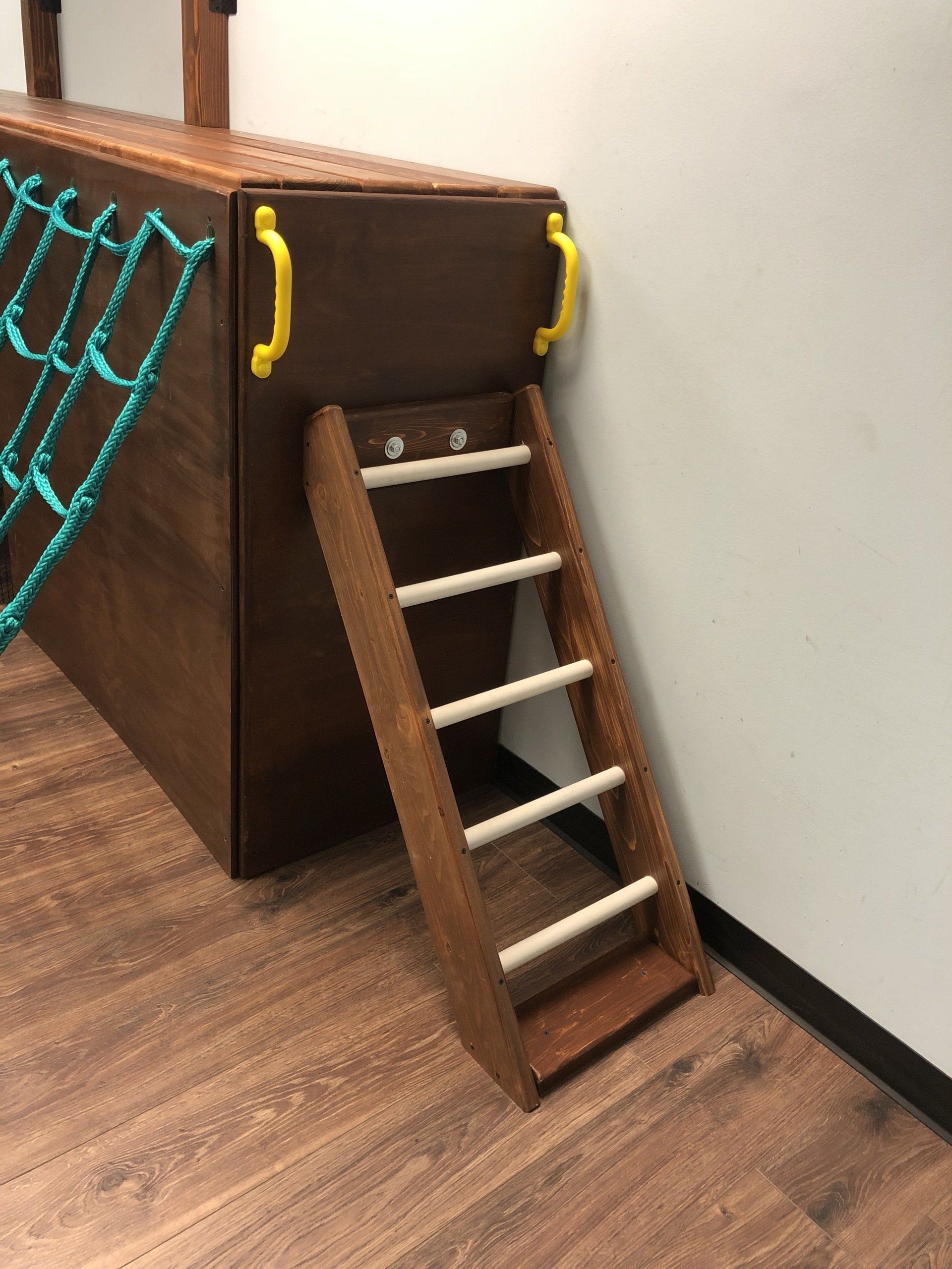 Custom angled ladder for a sensory gym structure