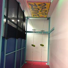 Indoor sensory gym zip line with platform, overhead track, and movement-based therapy equipment
