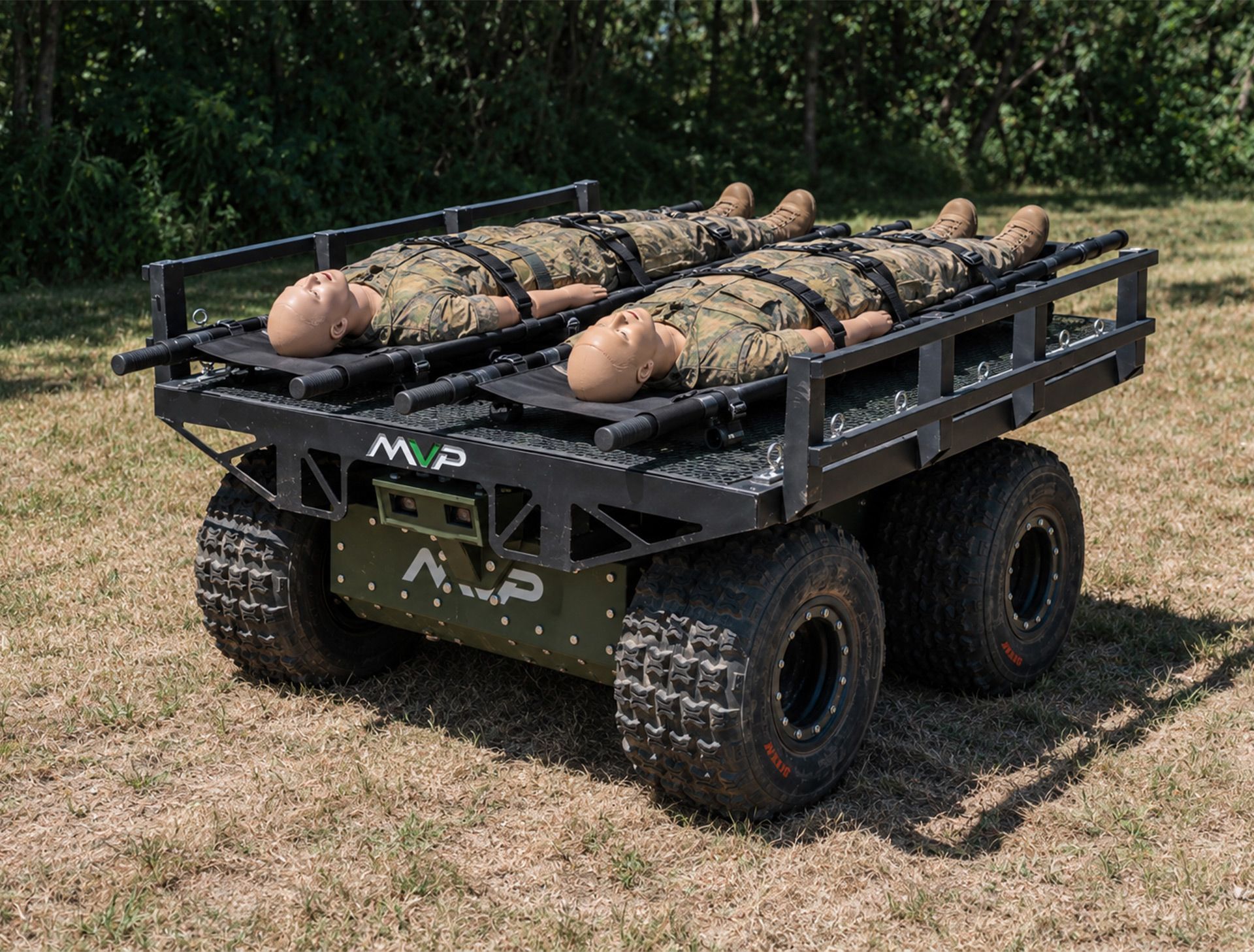 Black off-road utility trailer loaded with cut logs on a grassy field.