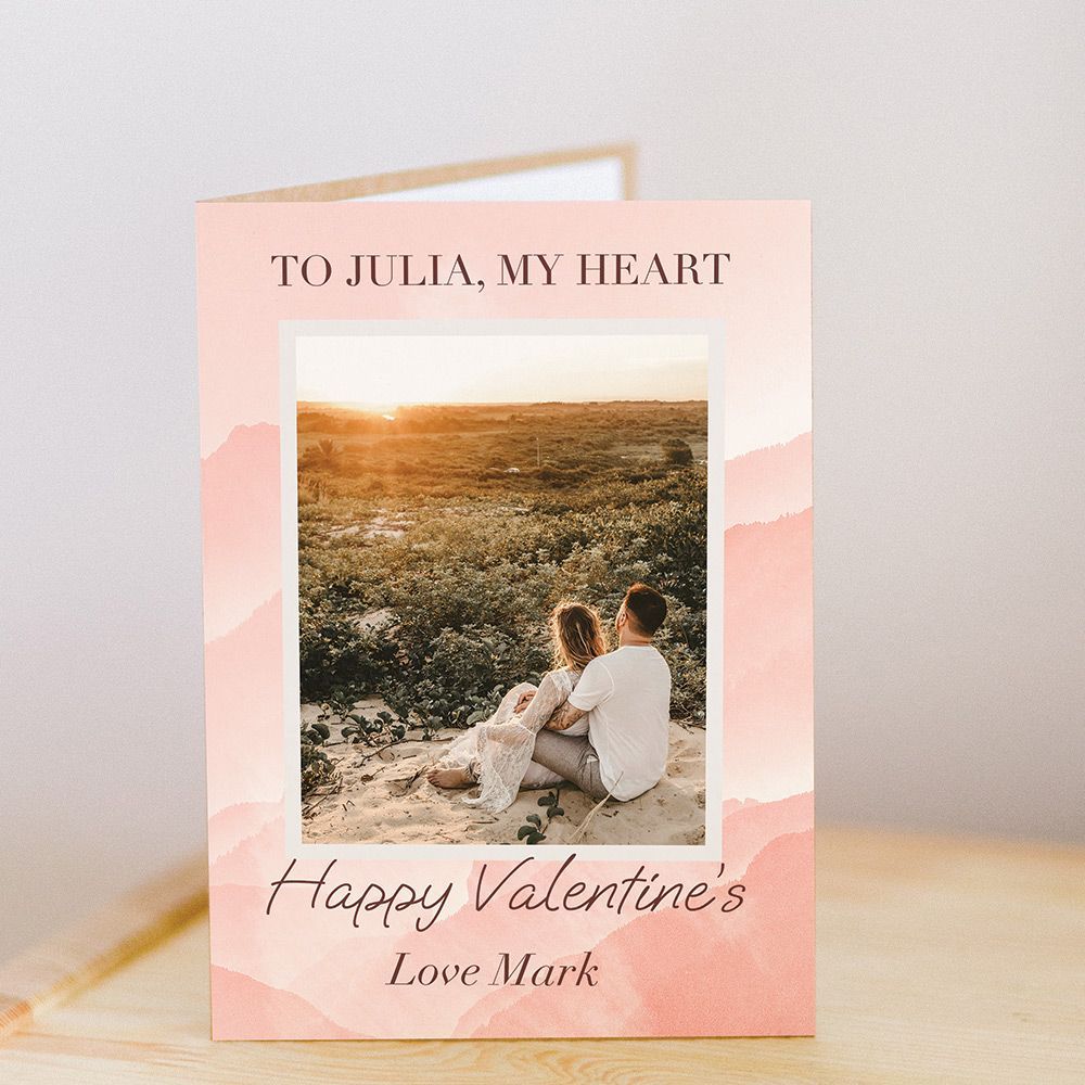 Valentine's Day card open on wooden table