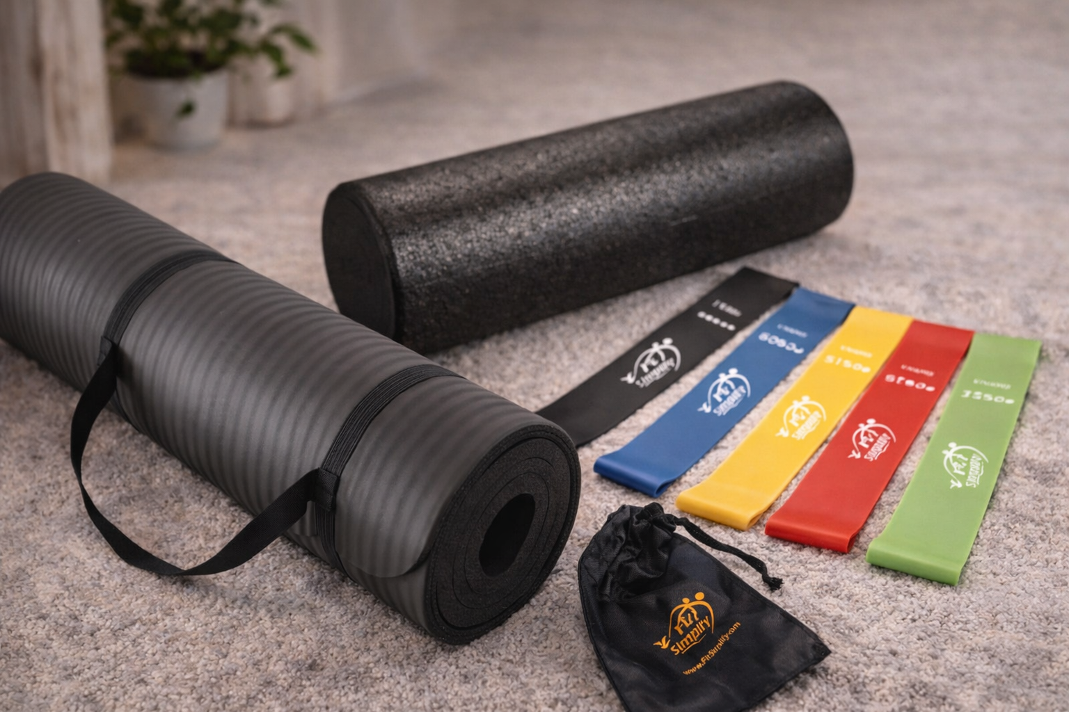 Black yoga mat, foam roller, and colorful resistance bands on a carpeted floor