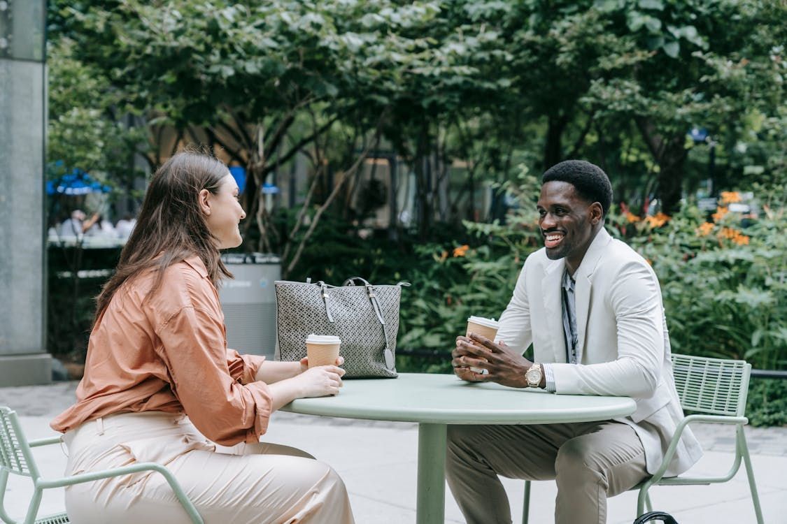 A couple sitting outside a cafe